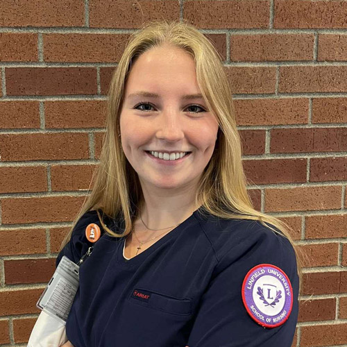 Portrait of Sydney Winters in her nursing scrubs.