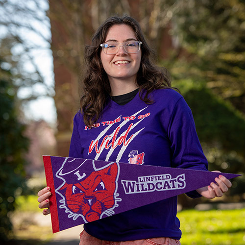 photo of student holding a giving day flag.