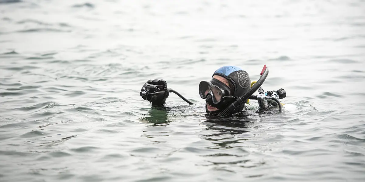 biology student scuba diving during an outdoor research class.