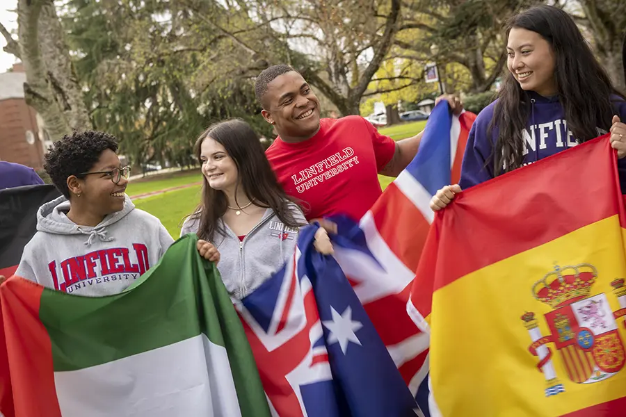 Divenson and other students holding flags from their home countries.