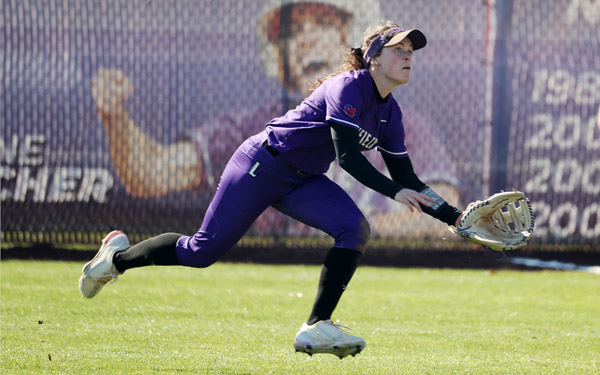 Baily catching a ball in the outfield during a softball game