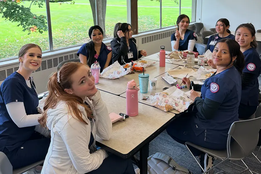 club members painting at a table.