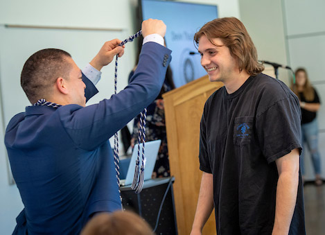 Devin receives his cords for the Tri-Alpha Honor Society.