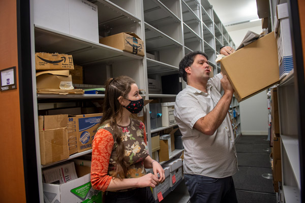 Layla helping Rich Schmidt return an item to the archives