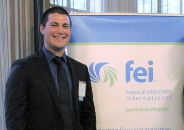 Owen posing in front of an FEI banner.