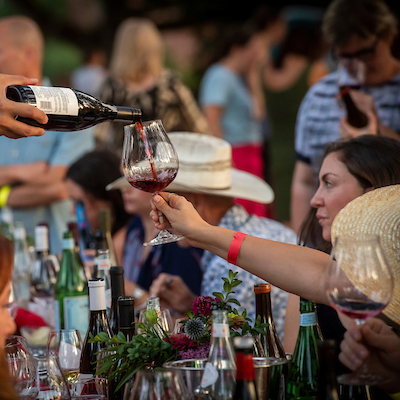 Guests holding wine glasses at IPNC.