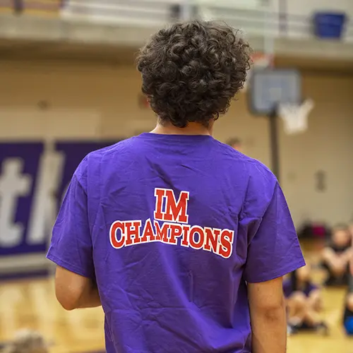 student wearing a shirt that says "IM Champion"