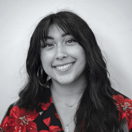 black and white portrait of female art student with her blouse in red