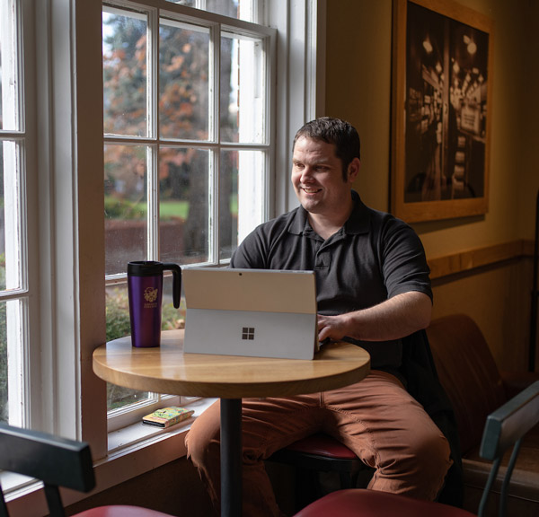 Student studying on his laptop in Starbucks