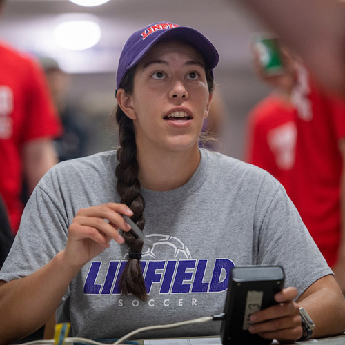 Female student working with student-athletes.