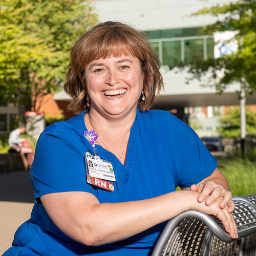 nurse in scrubs outside a hospital