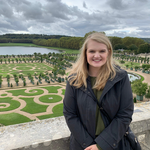 Female Linfield student in a park in France.